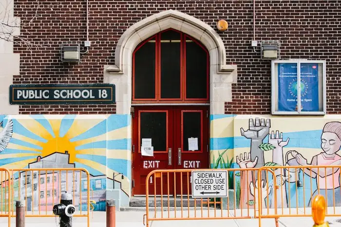 Closed doors can be seen in Edward Bush Public School 18 in Brooklyn, New York, USA, 16 March 2020. New York City Public schools will close due to coronavirus until at least April 20.